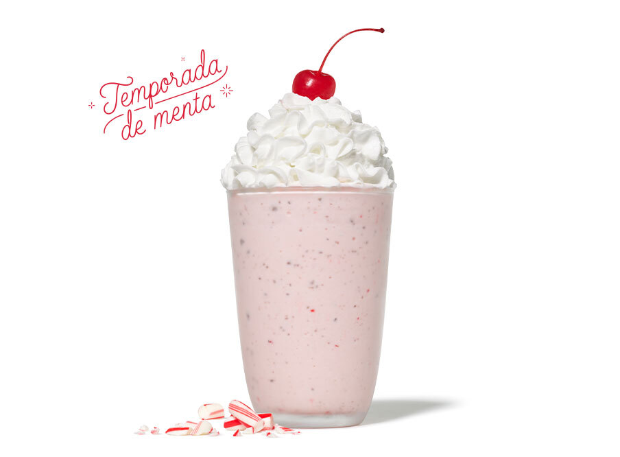 Peppermint milkshake with whipped cream, a cherry on top, and peppermint candy pieces, with the text
Temporada de menta