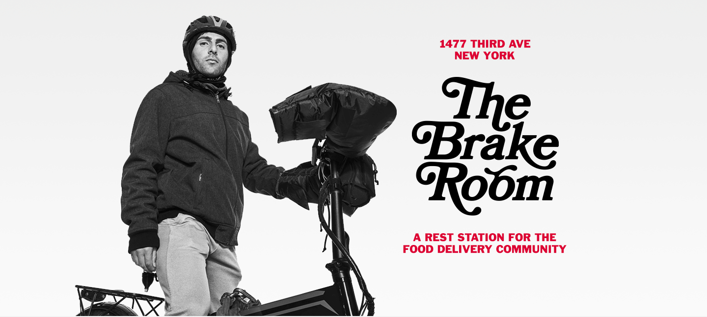 A person with a helmet stands next to an electric bicycle with a large bag. Black and red text on the right side, reading 1477 Third Ave New York | The Brake Room |
A rest station for the food delivery community

