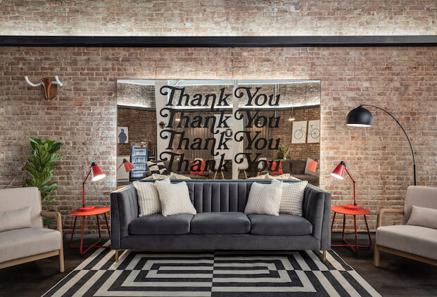 A modern, stylish lounge space with a cozy couch.