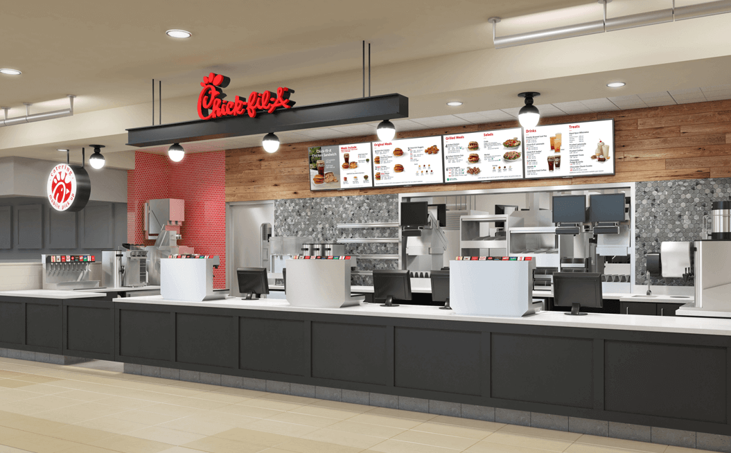 Interior of a modern Chick-fil-A restaurant with menu boards and ordering kiosks.