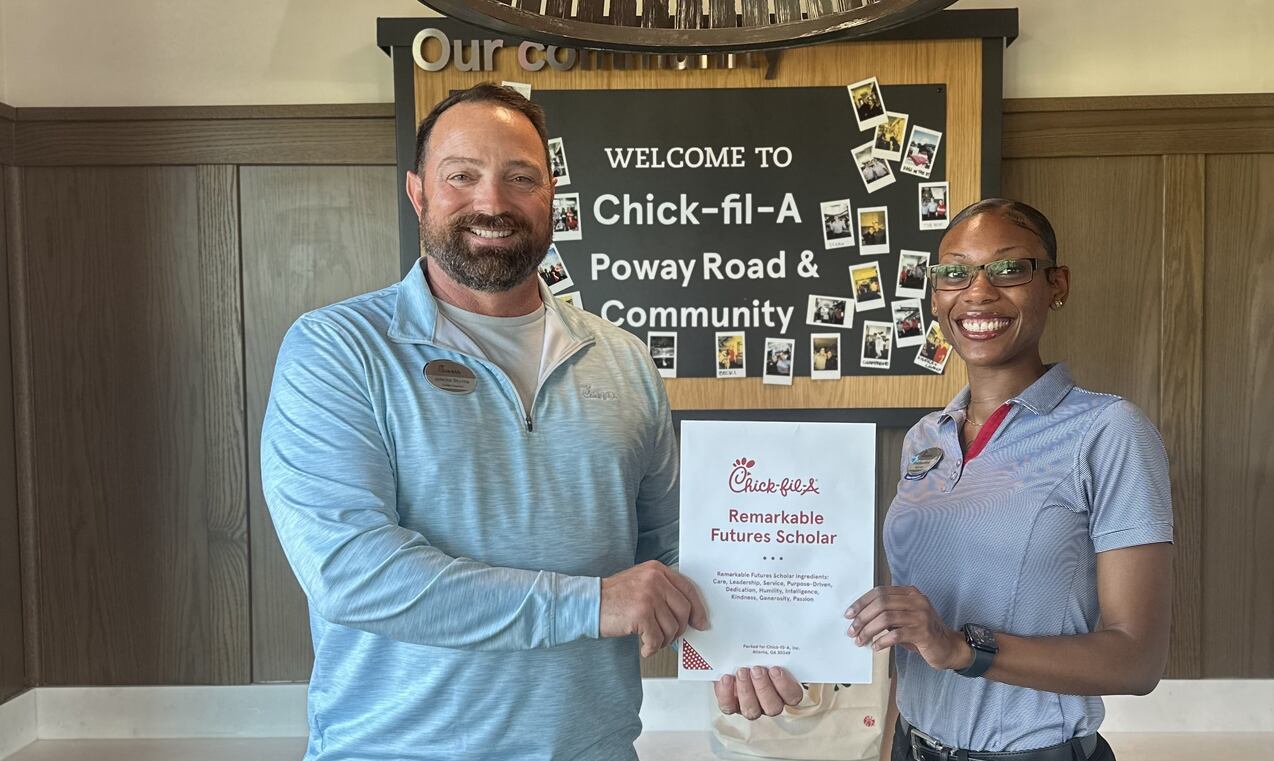 Jeremy Stump, the local Owner-Operator of Chick-fil-A Poway Road & Community in Poway, California presenting a Remarkable Futures Scholarship to a team member.