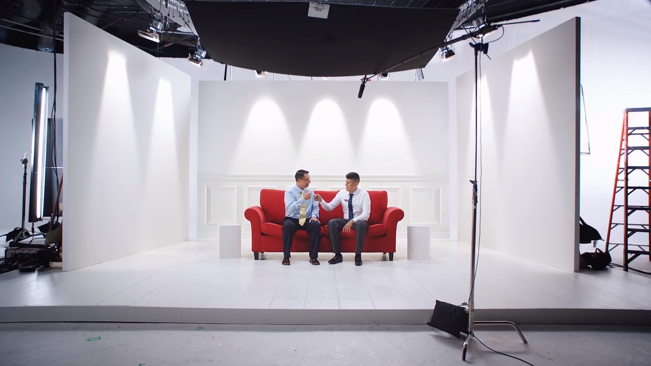 Two team members talking on read couch.