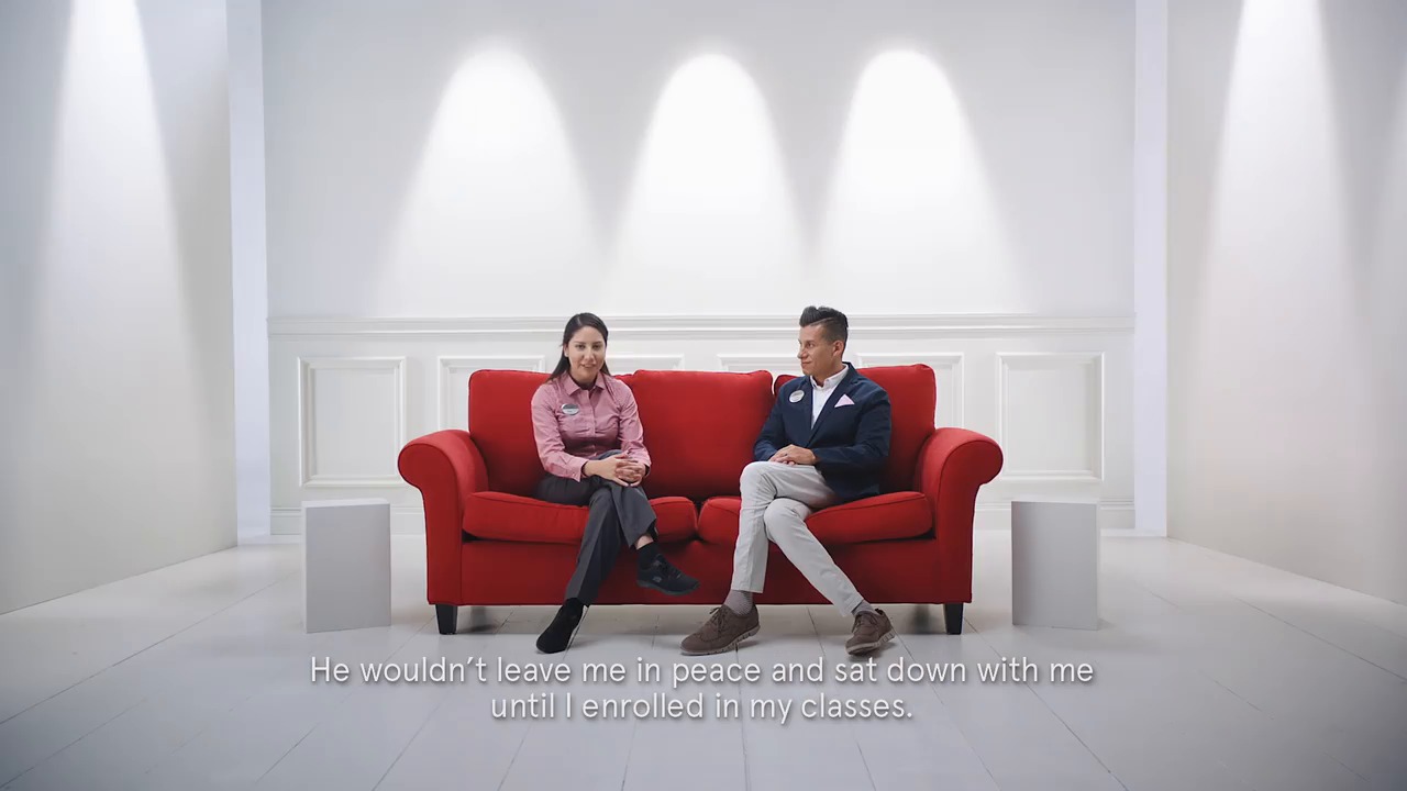 Two team members talking on read couch.