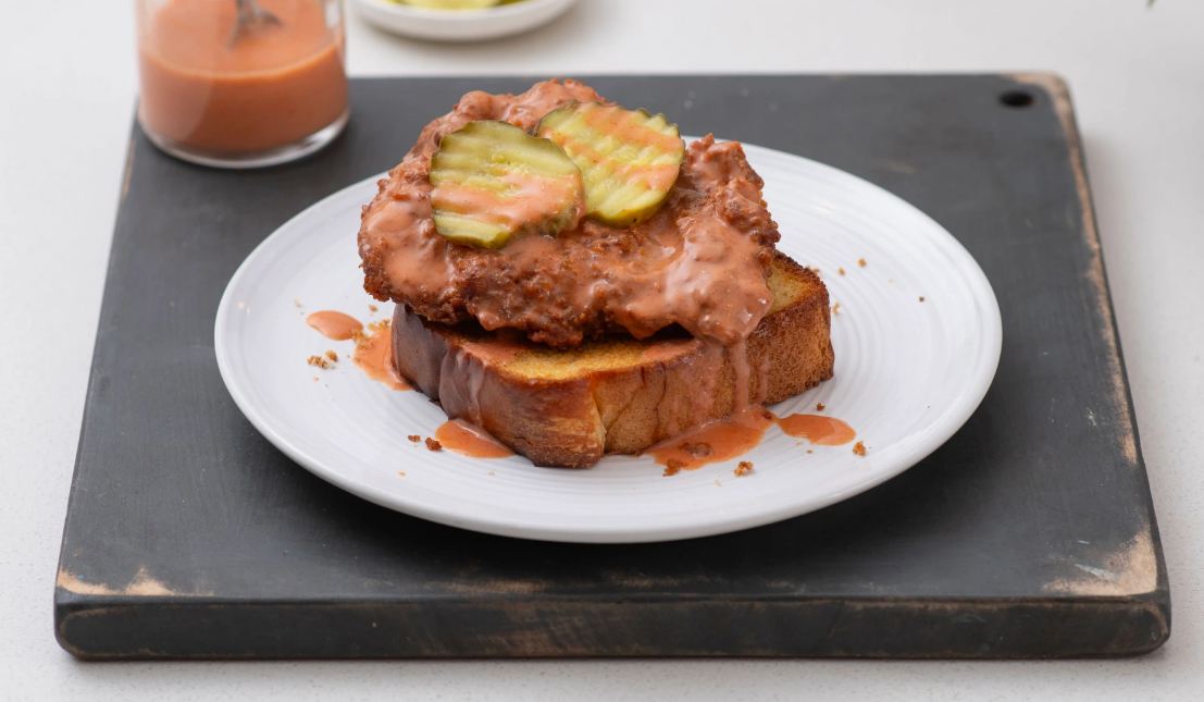 Nashville Hot Chick-fil-A Chicken Open-Faced Sandwich pickles and sauce on a white plate.