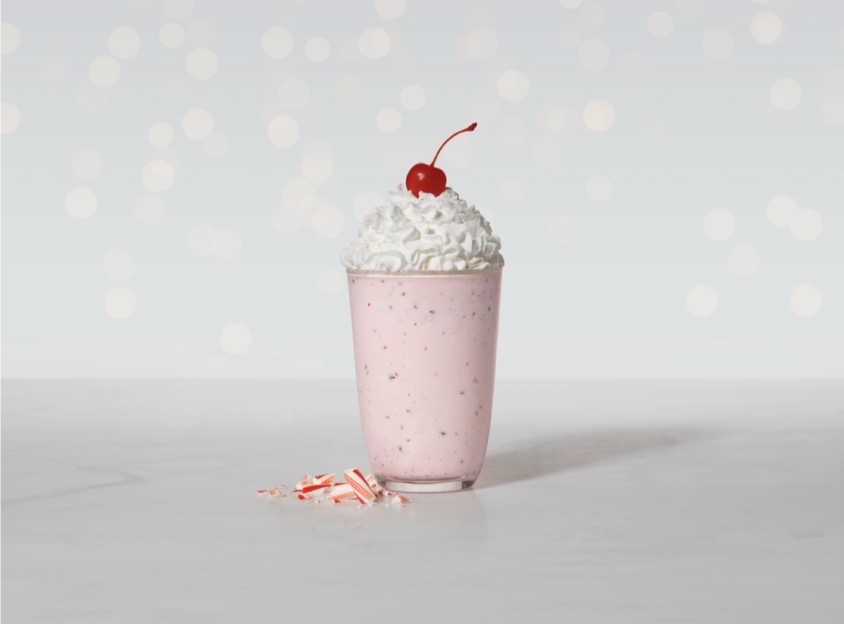 Broken candy canes next to a Peppermint shake.