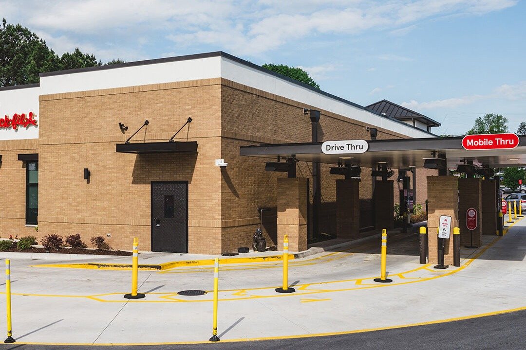 Two Mobile Thru lanes in the Chick-fil-A drive thru of a brick restaurant.