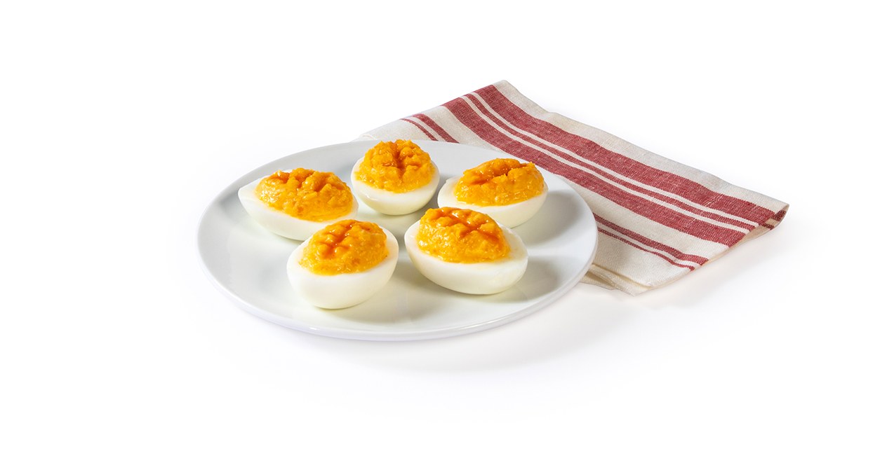 Football-themed deviled eggs on a white plate.