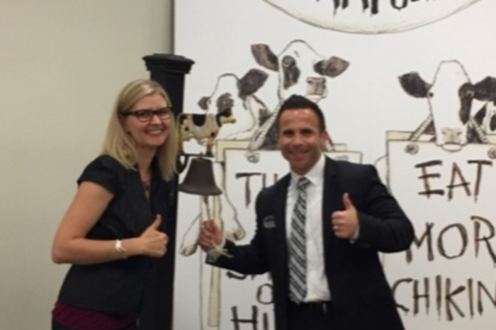 Matt and another person at the Chick-fil-a Support Center in Atlanta, in front of a bell.