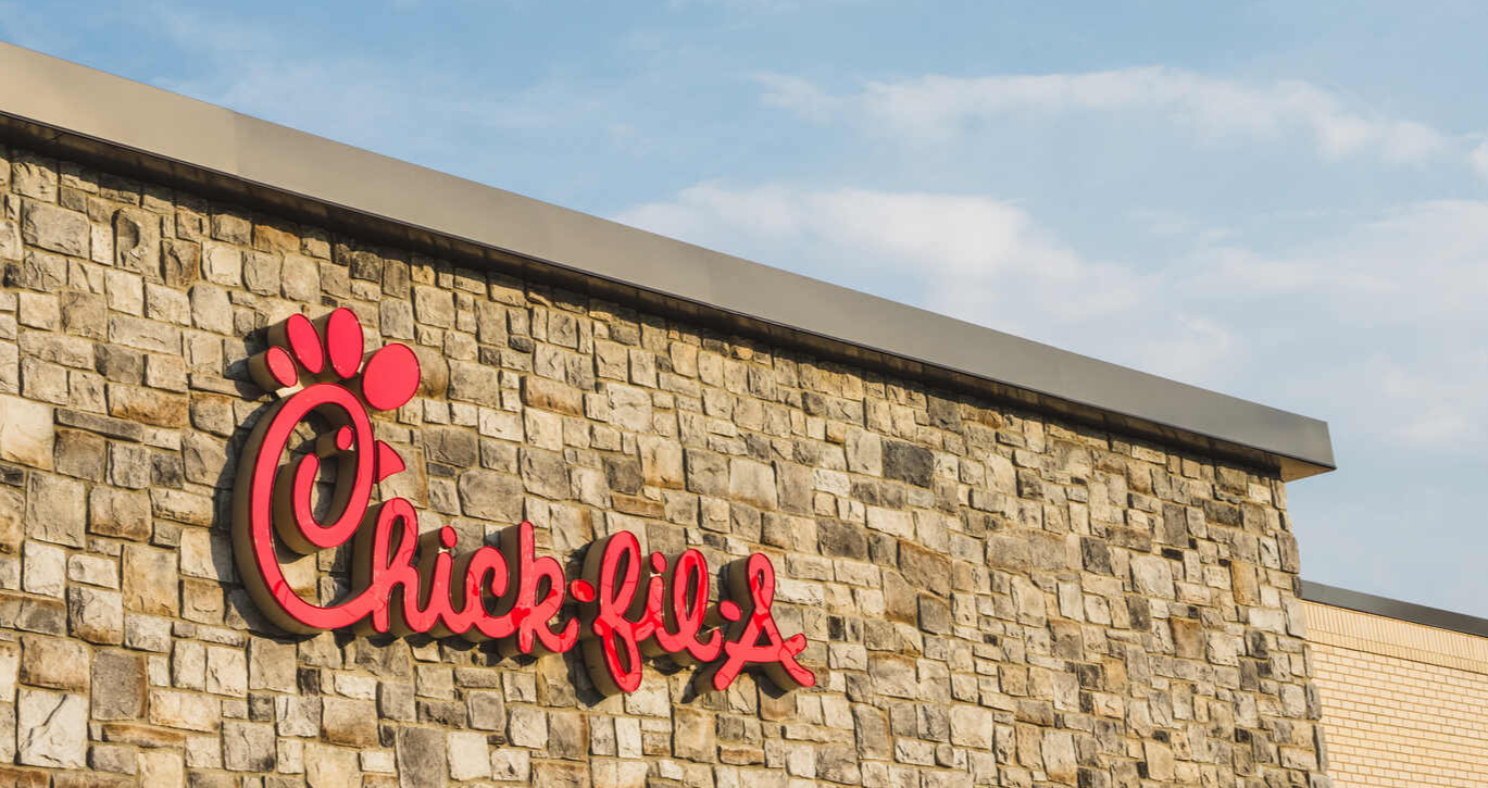 Stone building facade with a red Chick-fil-A logo.