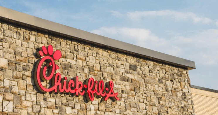 Stone building facade with a red Chick-fil-A logo.