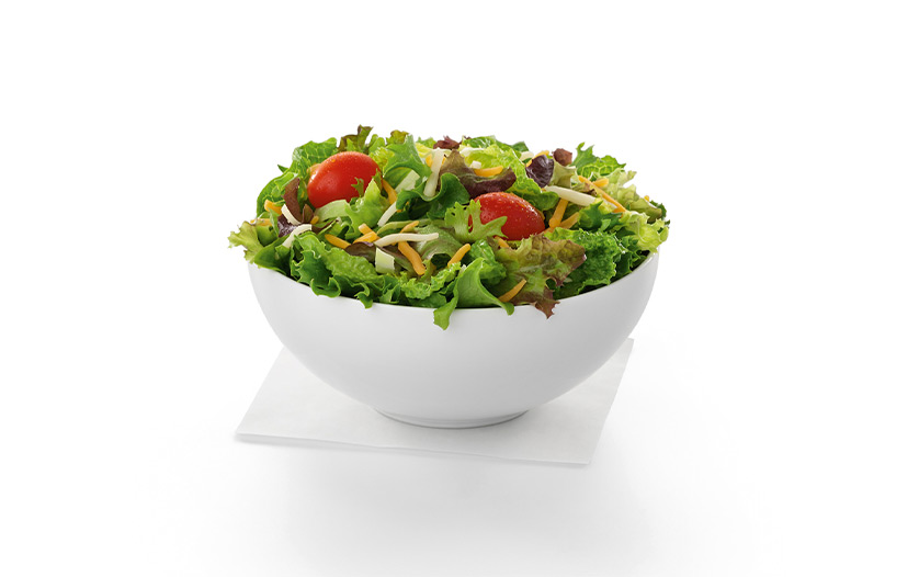 A side salad in a white bowl.