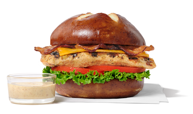 Grilled Pretzel Cheddar Club with a small glass cup of dijon mustard.