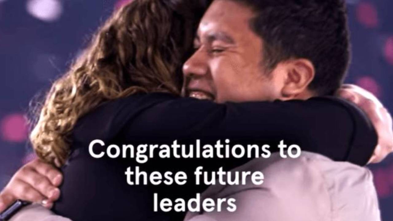 Team members embracing with the words Congratulations to these future leaders overlaid.