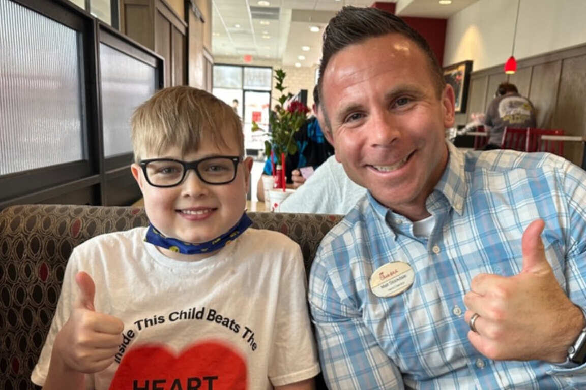 Matt Stockdale with a young customer both giving a thumbs up.