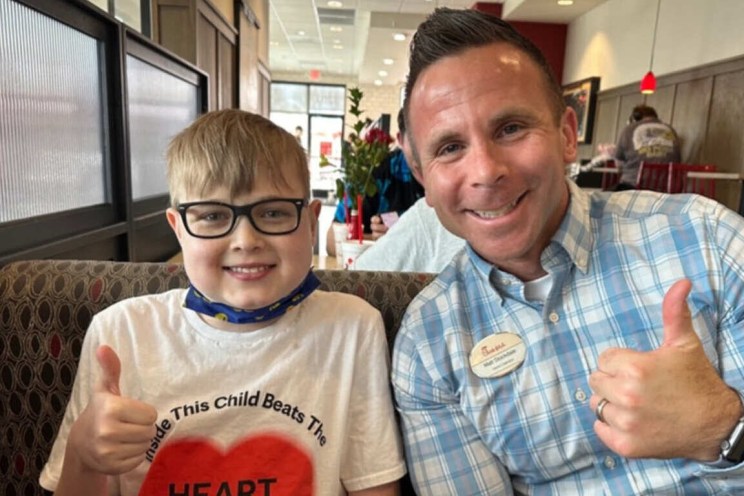 Matt Stockdale with a young customer both giving a thumbs up.