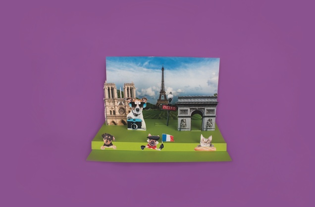 A Paris-themed diorama with the Eiffel Tower, Notre-Dame, Arc de Triomphe, and an assortment of animals dressed in French fashion.