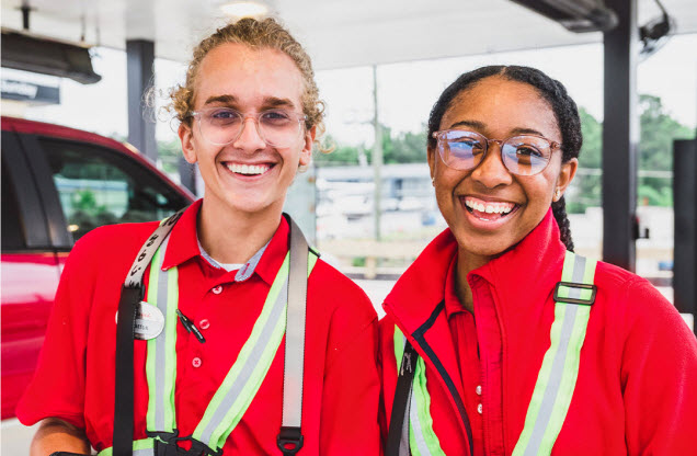 Two Team Members Smiling outside of Chick-fil-A location