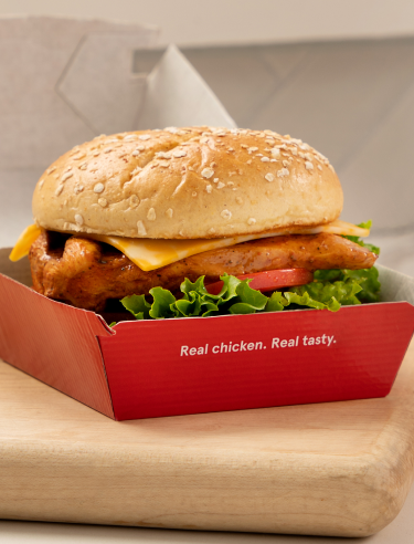 Chick-fil-A sandwich in a box that says "Real chicken. Real tasty."