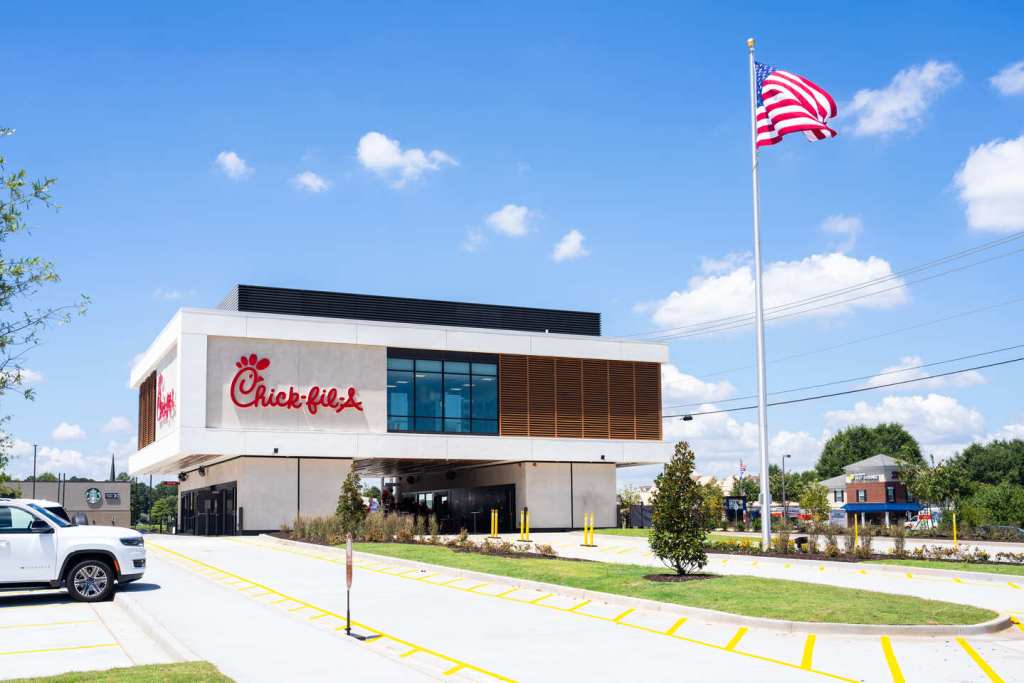 Chick-fil-A building with large windows and drive-thru lanes in front.