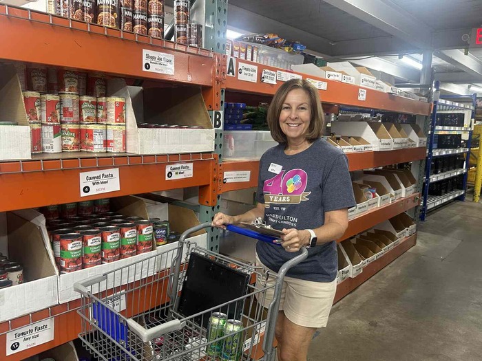 Volunteer helping with food distribution at NFCC.