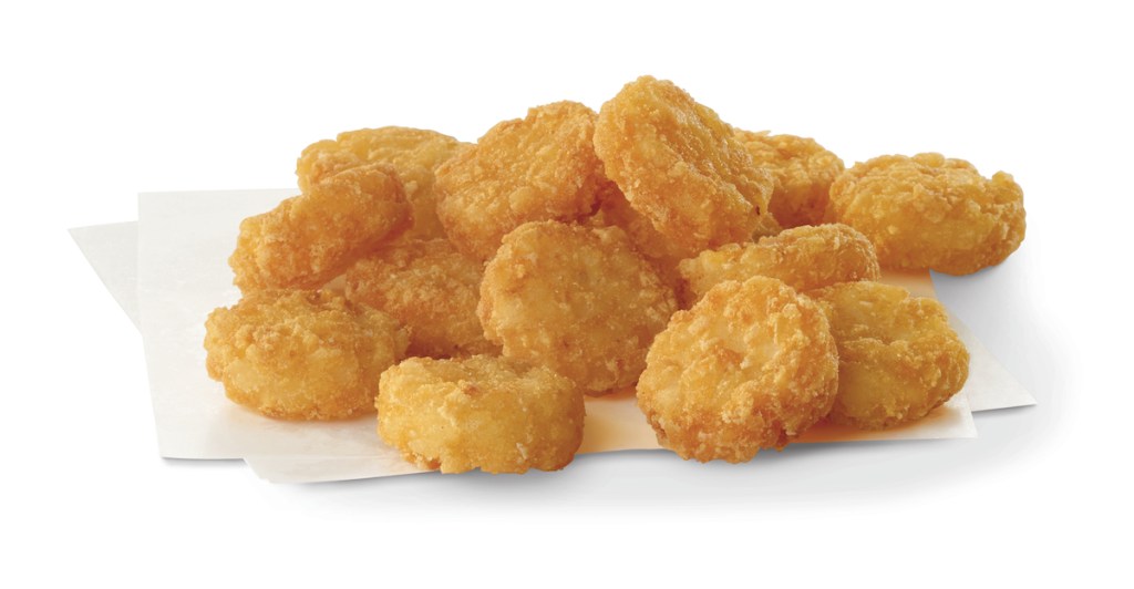 Crispy potato medallions on a white napkin.