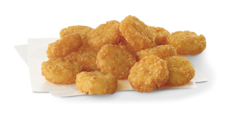 Crispy potato medallions on a white napkin.