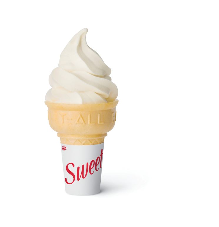 Soft-serve ice cream in a cake cone with a wrapper that says Sweet.