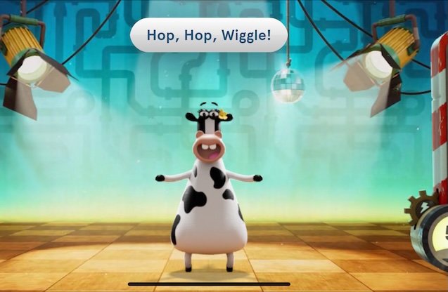Daisy the Cow smiling and standing on a stage 