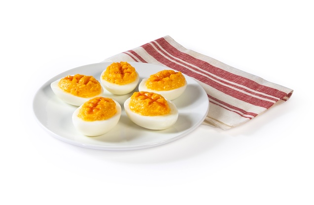 Five Polynesian Footballs on a white plate with a red and white cloth napkin