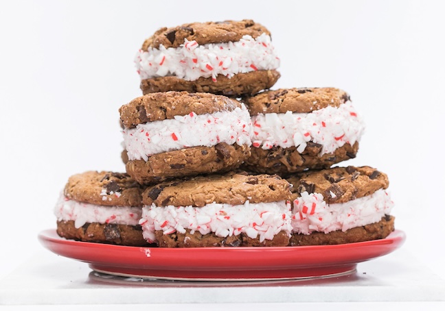 Red plate stacked with Peppermint Chocolate Chunk Cookie Sandwiches