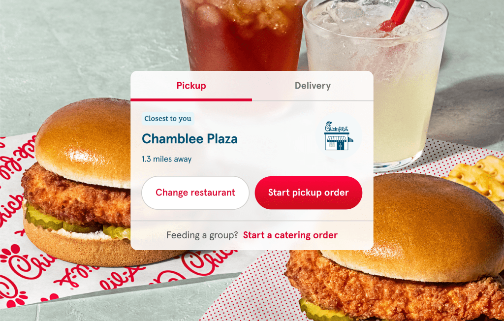 Two Chick-fil-A® Chicken Sandwiches sitting on parchment paper and a glass of Iced Tea and a glass of Chick-fil-A® Lemonade behind them