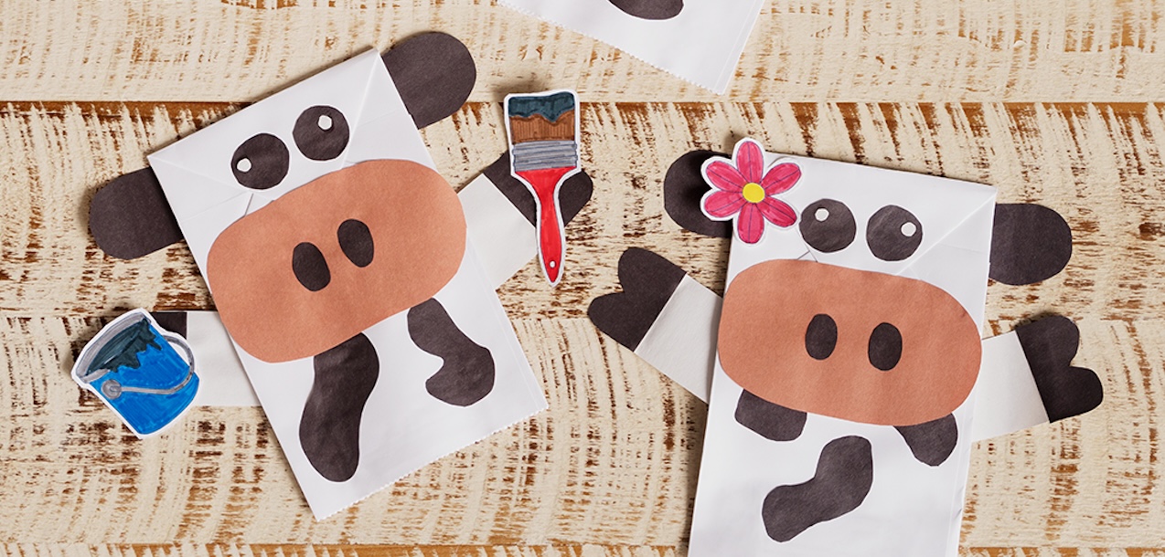 Two Cow Puppet crafts laying on a table