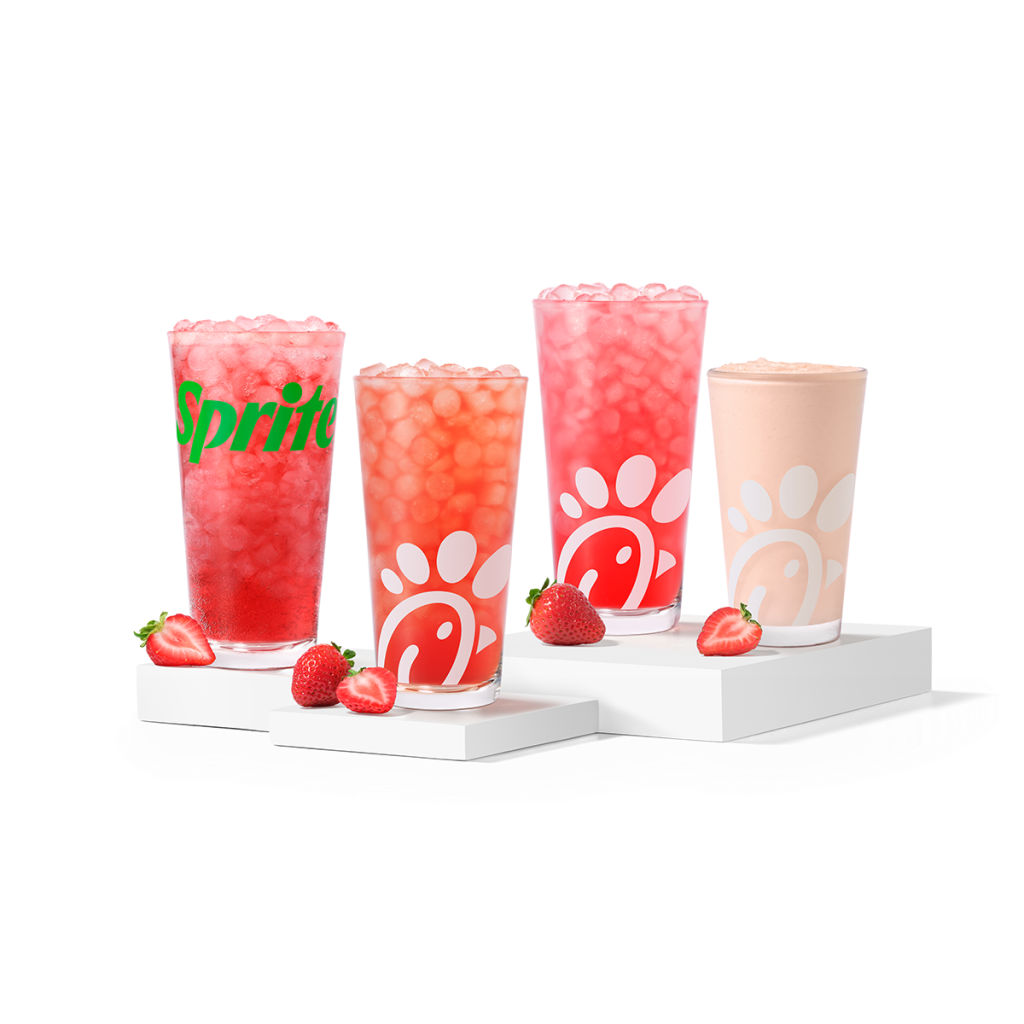 Strawberry Hibiscus & Sprite®, Sunjoy®, Lemonade and Frosted Lemonade, made with natural strawberry and hibiscus flavors, sitting on risers with strawberry slices
