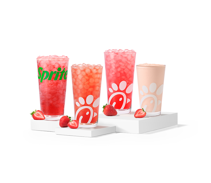 Strawberry Hibiscus & Sprite®, Sunjoy®, Lemonade and Frosted Lemonade, made with natural strawberry and hibiscus flavors, sitting on risers with strawberry slices