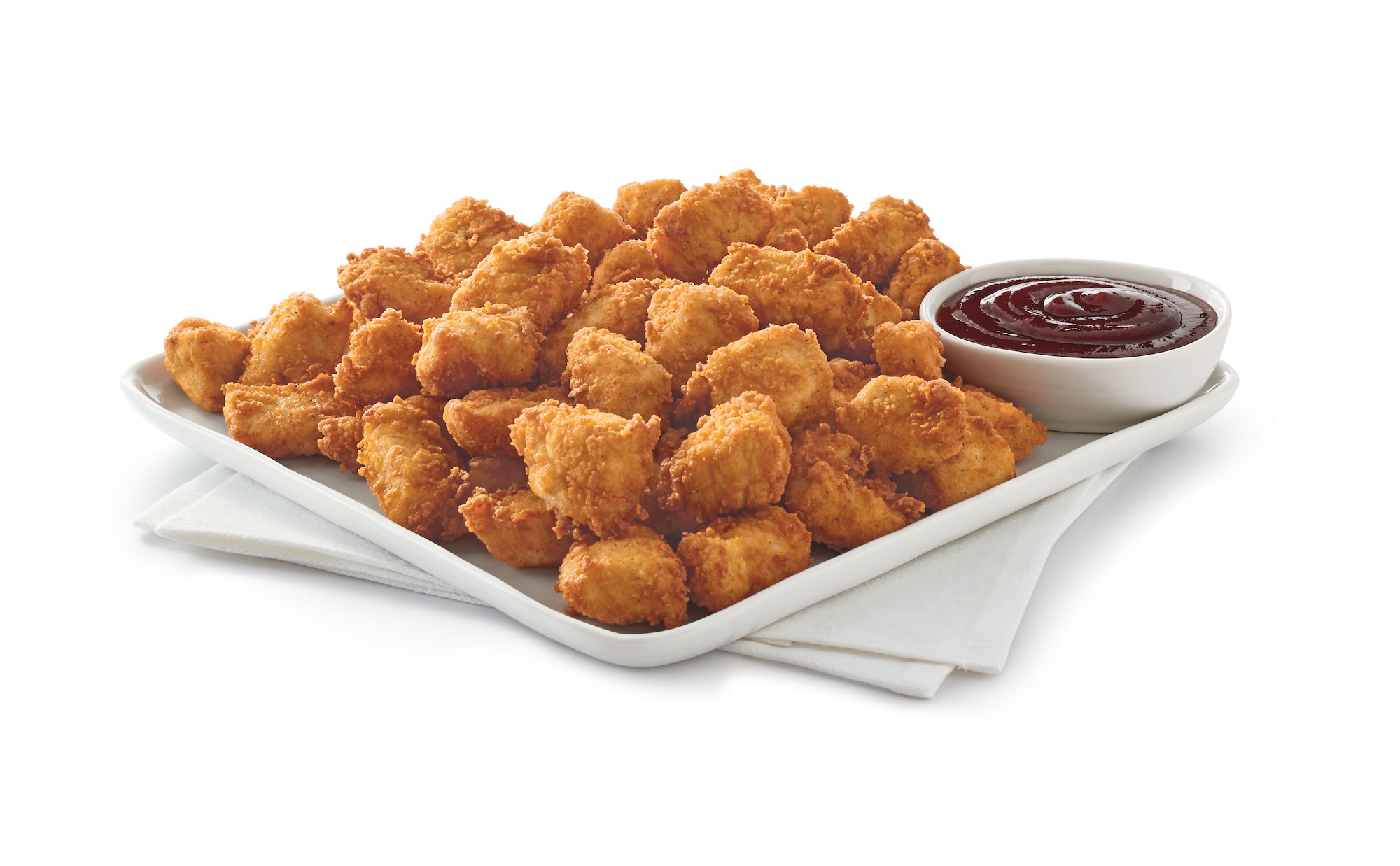 Chick-fil-A® Nuggets Tray on a white platter on white napkins with a side of Barbecue Sauce