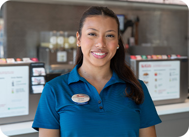 Headshot of Team Member Yamanni standing in a Restaurant smiling
