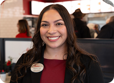Headshot of Team Member Precious standing in a Restaurant smiling