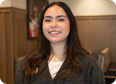 Headshot of Team Member Danna standing in a Restaurant smiling