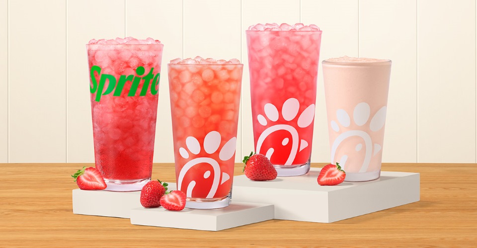 Strawberry Hibiscus & Sprite®, Sunjoy®, Lemonade and Frosted Lemonade, made with natural strawberry and hibiscus flavors, sitting on risers with strawberry slices