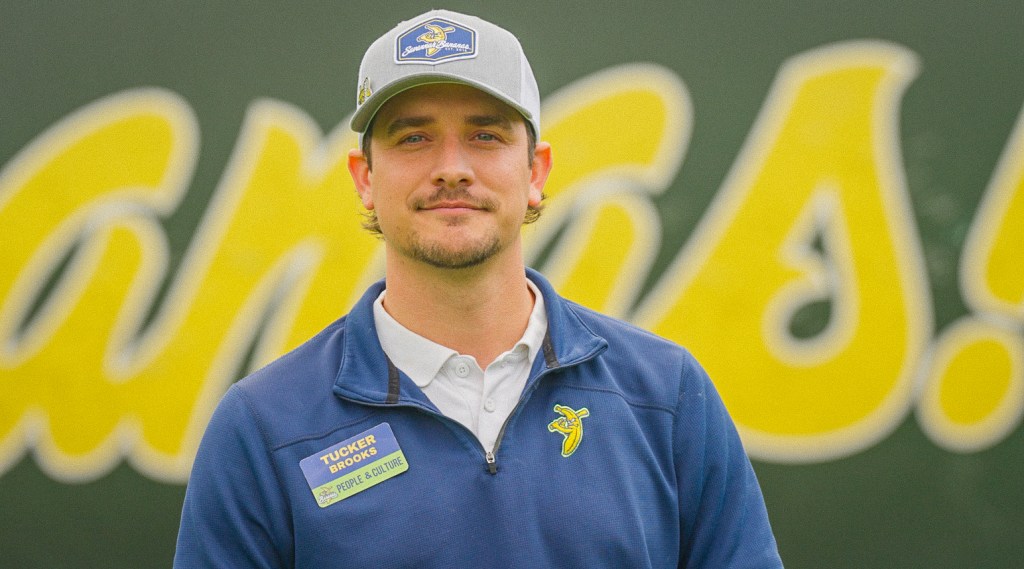 Tucker Brooks from the Savannah Bananas smiling at the camera.