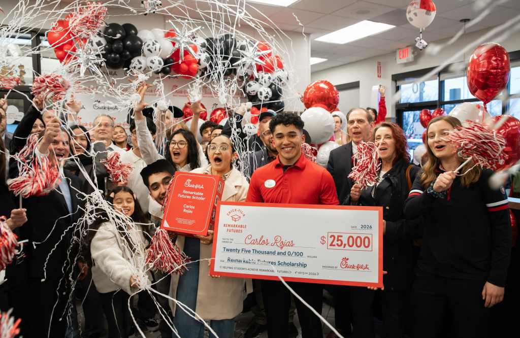 An image of Carlos Rojas, a Team Member at a Chick-fil-A in Schaumburg, IL celebrating his Remarkable Futures Scholarship in the Restaurant with his team.