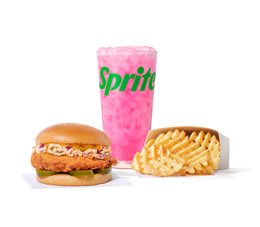 Honey Pepper Pimento Chicken Sandwich with an original filet next to Waffle Fries and a Pineapple Dragonfruit & Sprite®