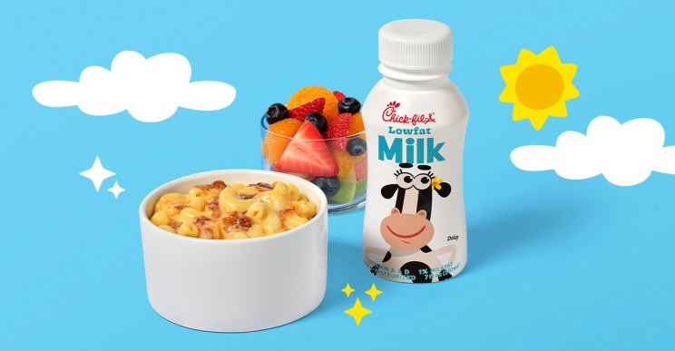 Kid's Meal Mac & Cheese next to a Fruit Cup and a milk on a blue background with clouds and a sun