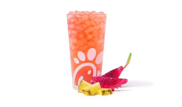 A glass of Pineapple Dragonfruit Sunjoy® with slices of pineapple and dragonfruit