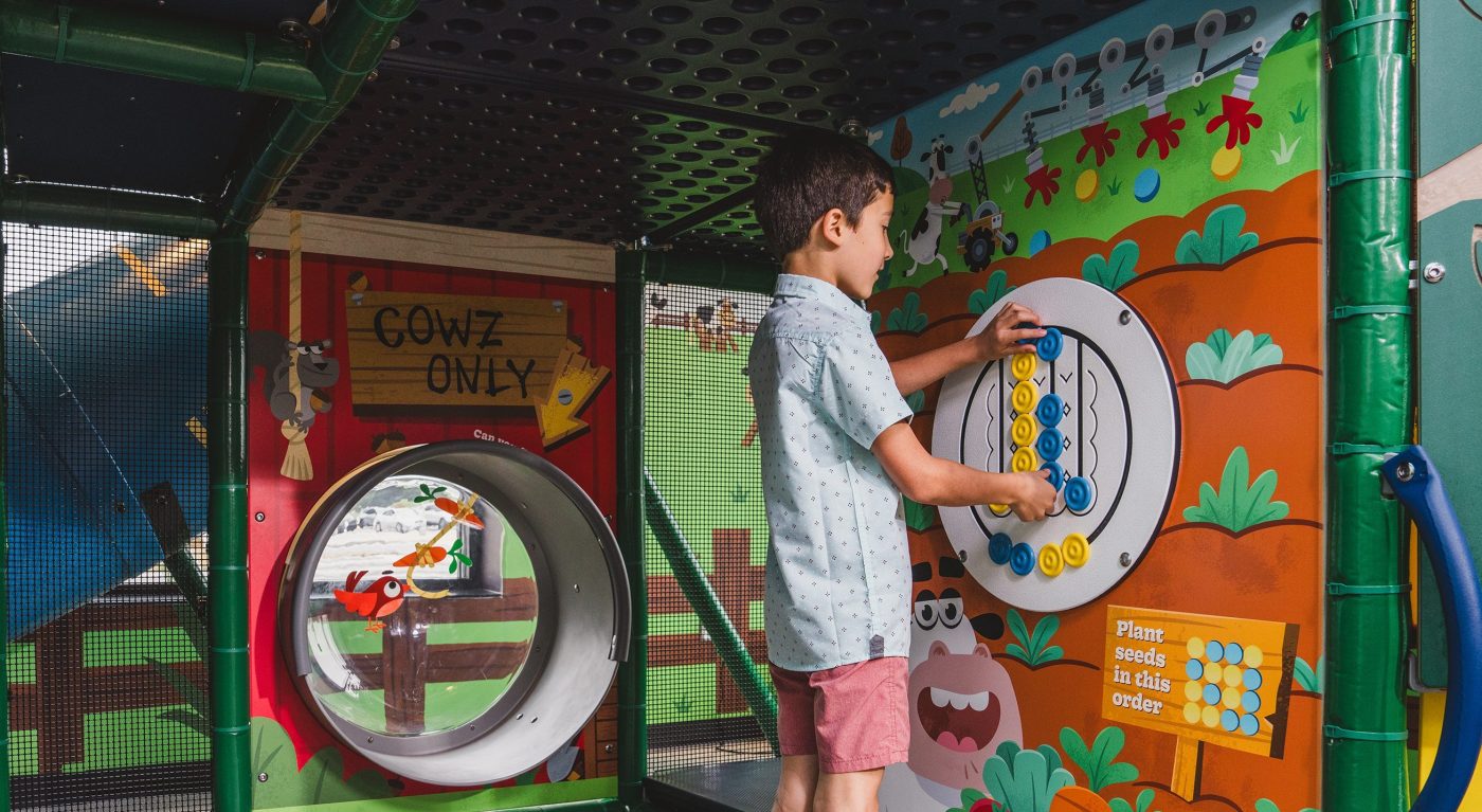 Boy playing on new Chick-fil-A playground.