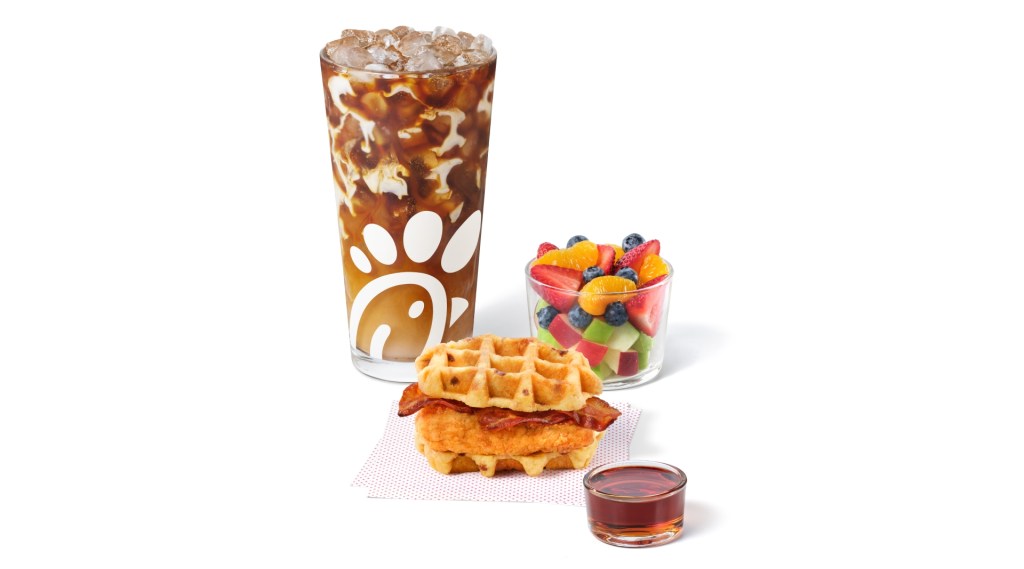Chicken & Waffles Sandwich meal with the Cream Cold Brew and side of fruit.