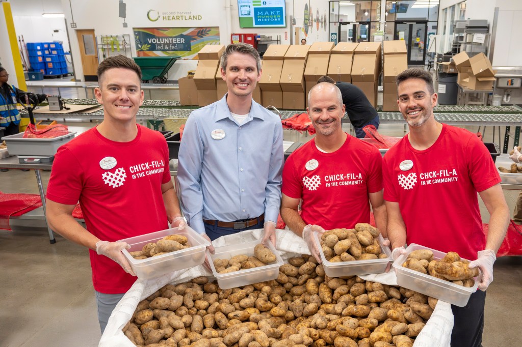 Chick-fil-A Team Members volunteer at Second Harvest Heartland food bank, sorting potatoes for distribution.