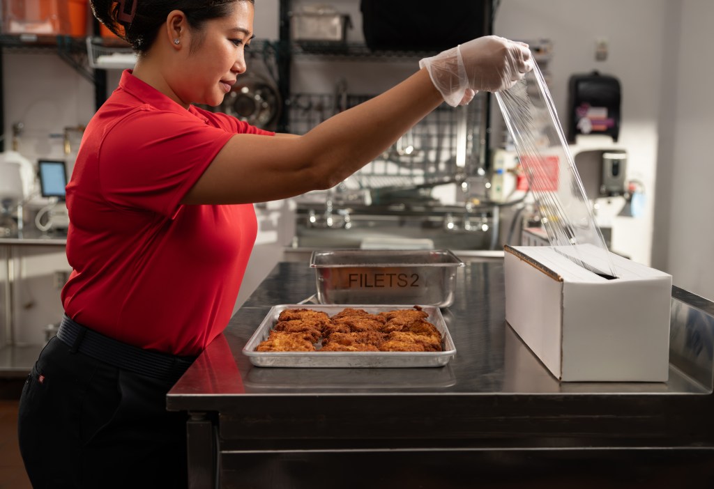 A Chick-fil-A Team Member packing up Shared Table food donations.