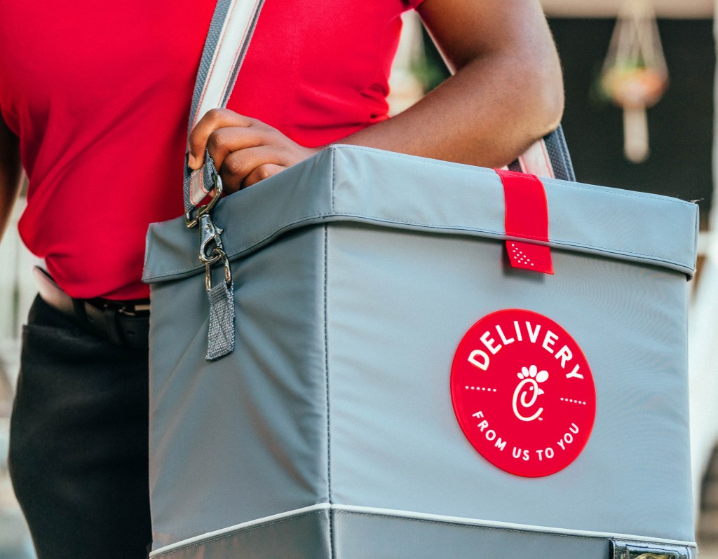 Team Member holding a Chick-fil-A® Delivery bag